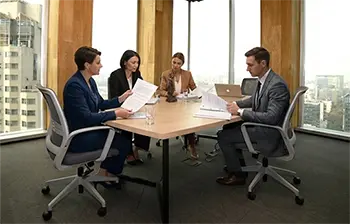 Attorneys in a conference room meeting with clients